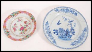 Two 18th Century Chinese plates to include a famille rose example of circular form and a blue and