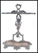 A late 19th / early 20th Century cast iron stick stand having an ebonised painted finish. The