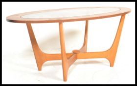 A retro mid 20th century teak wood atomic ' Astro ' lozenge shaped coffee table in the manner of G