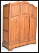 A late 19th Century mahogany French triple armoire wardrobe having a taller central section