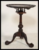 An antique style tripod wine occasional table raised on ball and claw feet with birdcage tilt top