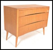 A vintage retro mid 20th Century teak wood Beehive fronted chest of drawers having a bank of three