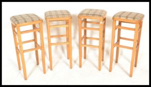 A set of four vintage retro 20th century beech framed tall breakfast bar stools with upholstered
