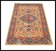 A vintage 20th Century Persian Islamic carpet rug having a large five colour tree of life decoration