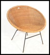 A retro mid 20th Century satellite sputnik atomic cane / wicker tub chair raised on ebonised tubular