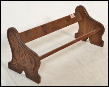 A 19th Century Chinese hardwood book trough of typical form having hand carved knotted dragon