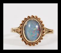 A vintage 20th Century hallmarked 9ct gold ring having a central opal panel in rope twist and bead