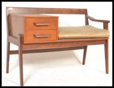 A vintage retro 20th Century teak wood telephone table / window seat raised on tapering square