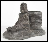 An early 20th Century white metal spelter figural match striker / strike  in the form of a