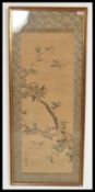 A Japanese late 19th Century Meiji period hand painted silk panel depicting birds and trees.