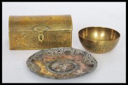 A selection of brass wears to include a hand worked Islamic brass prayer bowl with patterned