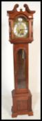A 20th Century long case clock marked for John Coombs of Weston Super Mare having a white chapter