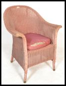 A vintage early to mid 20th Century Lloyd Loom conservatory / garden wicker style armchair, having a