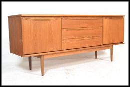 A retro 20th Century teak wood sideboard / credenza, having a bank of three central drawers