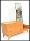 A 1960's retro upright blond oak dressing table by Meredew. Raised on angular legs with a series