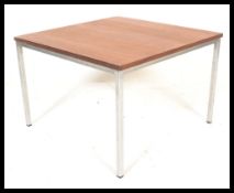 A vintage retro 20th Century teak coffee table of square form raised on chrome metal legs.