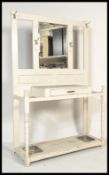 A 19th Century Victorian white painted hall stand raised on block and turned legs with carved
