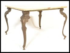 A vintage 20th century gilt brass coffee table having a rectangular onyx top raised on shaped