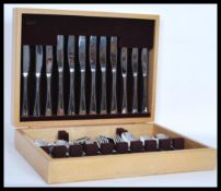 A vintage 20th Century canteen of cutlery by Arthur Price complete in fitted light oak flatware box.