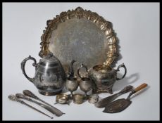 A collection of silverplate items to include a teapot having engraved foliate decoration and acorn