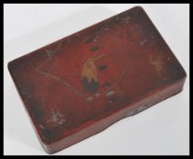 An early 20th Century Japanese red oil Murashido ware card box having decoration depicting