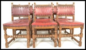 A set of six oak and leather Old Charm dining chairs raised on block and turned supports with