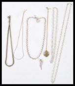 A selection of silver necklaces to include two snake chains, a belcher link chain with a toggle