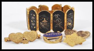 A vintage Japanese gold plated panel bracelet constructed from 10 panels with gilt landscape and