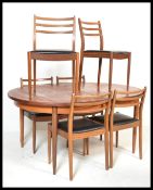 A  retro 20th Century G-Plan Fresco range extendable teak wood dining table together with a set of