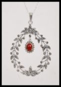 A stamped 925 silver necklace having a floral garland pendant set with marcasites and a coral