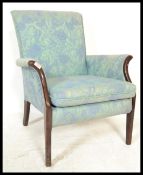 A 20th Century retro Parker Knoll fireside / lounge armchair, dark wood show frame raised on