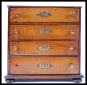 A 19th Century Victorian salesman miniature / apprentice piece chest of drawers. The bank of four