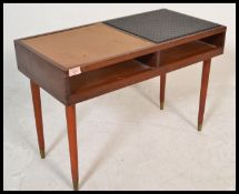 A vintage retro 20th Century teak wood telephone table raised on tapering legs with brass feet.