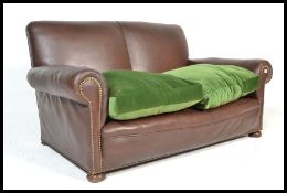A vintage 20th Century leather Chesterfield two seater club sofa settee, the sofa with scroll arms