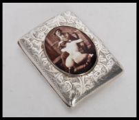 A hallmarked vesta case having engraved decoration to the exterior and an enamelled panel to the