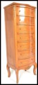 A 20th Century Continental French king wood seven day chest of drawers having ormolu mounts with