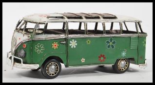 A retro vintage style tinplate type large sized model of a VW Volkswagen campervan having floral