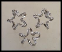 A stamped 750 white gold demi parure earrings and pendant set to include a pair of twisted design