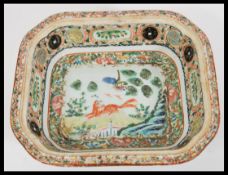 An early 20th Century Chinese bowl of octagonal form having a central white cartouche panel