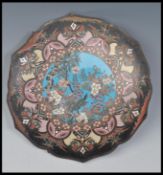 A late 19th Century Japanese Cloisonne charger plate of scalloped form having central blue enamel