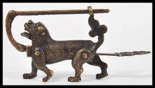 A Chinese 19th Century bronze lock and key in the form of a Dog of Fo having articulated legs.