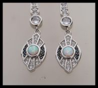 A pair of stamped 925 silver Art Deco style drop earrings set with cz accent stones, with opal