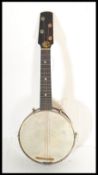 An early / mid 20th Century four string banjolele marked Pele, having an ebonised wood fretboard,