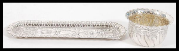 A silver hallmarked dressing table trinket tray having repousse scrolled and reeded decoration (