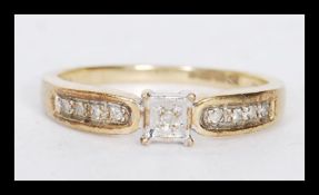A hallmarked 9ct gold ring having a central square illusion set diamond with diamond set
