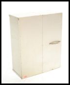 A retro 20th Century industrial brushed metal wall cupboard cabinet having a hinged sectional door