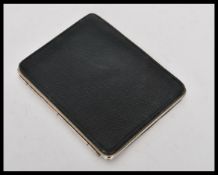 A vintage 20th Century leather calling card case having a white metal clasp with sectional interior.