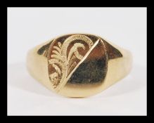 A vintage 20th Century hallmarked 9ct gold large signet ring having a half engraved plain armorial