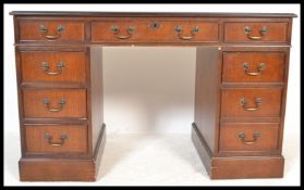 An Antique Georgian style mahogany twin pedestal desk having gilt tooled leather skiver with drawers