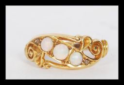 A late 19th Century / early 20th Century 18ct gold ring set with three opal cabochons having